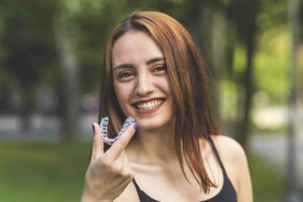 Woman Smiling with Invisalign Retainer